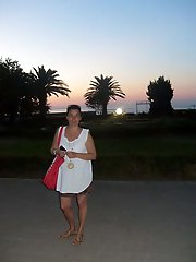 Adorable aged mama is walking on the street