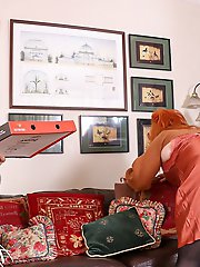 Aroused older woman with red hair on top of a younger man