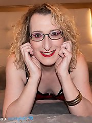 English mature beauty Lisa Essex reclining on the bed in alluring undergarments